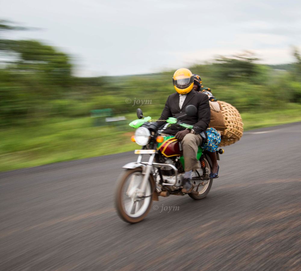 A boda boda rider in a helmet on a Nairobi street